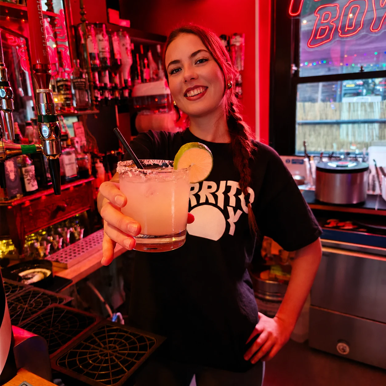 Burrito Buoy team member serving a cocktail