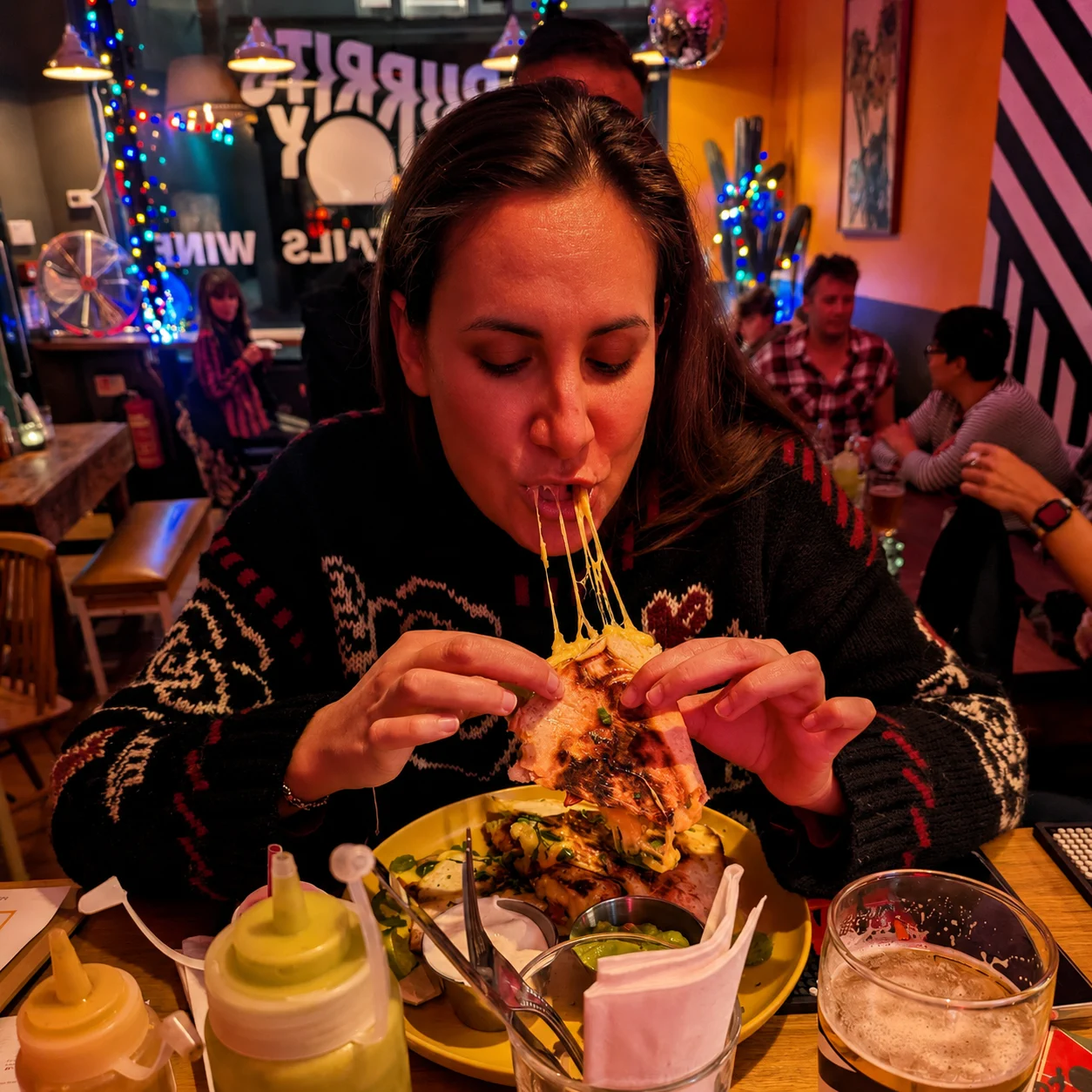 A guest enjoying a cheesy Burrito Buoy dish