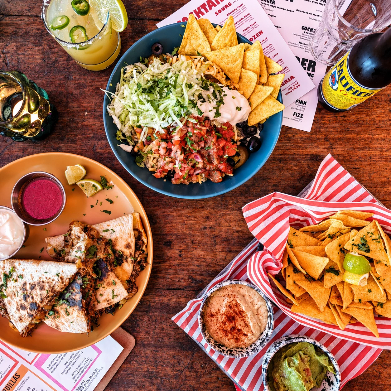 Burritos, nachos and dips served across a Burrito Buoy table