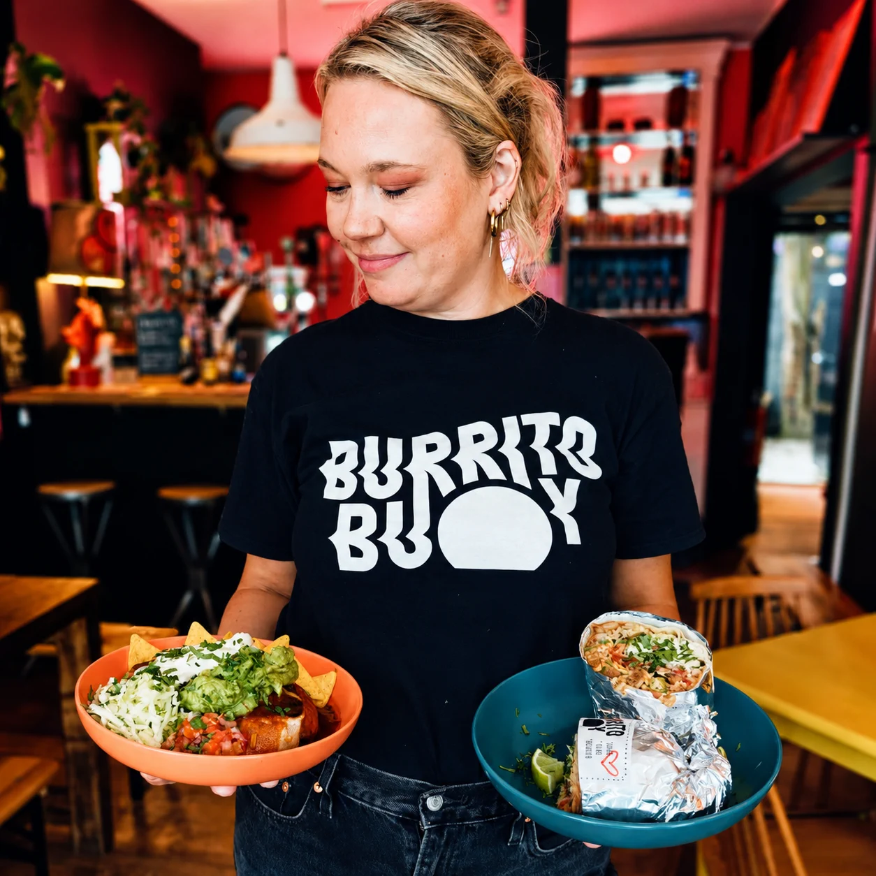 Burrito Buoy team member holding a burrito and bowl